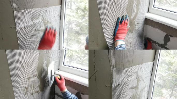 修理工用油灰刀抹灰墙