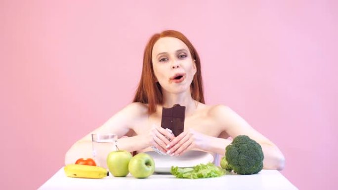 快乐厌食症女孩贪婪地吃巧克力。违反饮食。糟糕的饮食。厌食症。