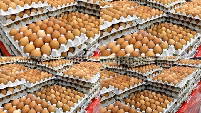 鸡蛋成排堆叠。纸箱里的新鲜棕色鸡蛋堆