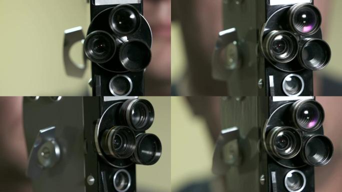 男子拍摄与老式8毫米电影摄影机。缠绕和启动电机。