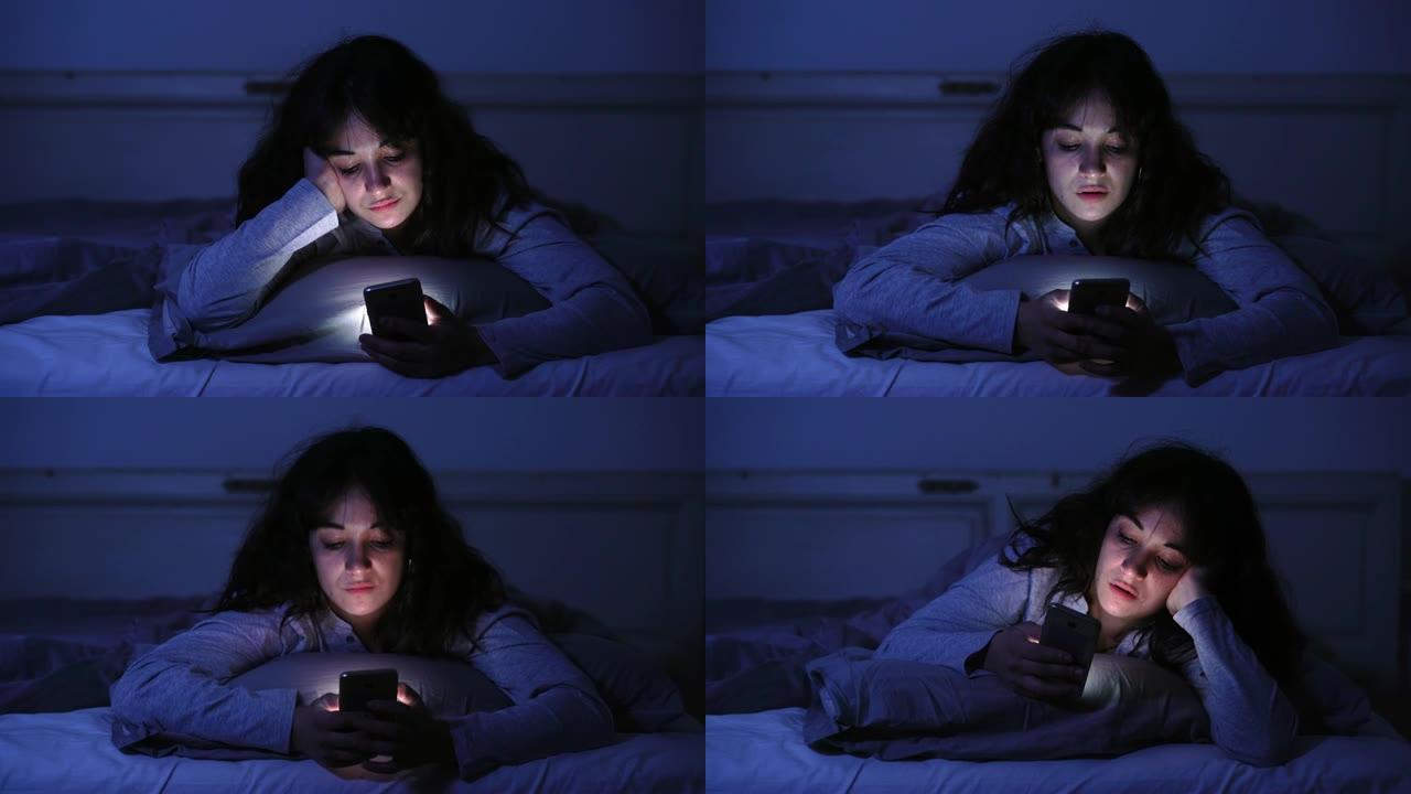 4k宽的视频，一个上瘾的年轻女子使用她的智能手机在互联网上聊天和冲浪，深夜困倦，无聊和疲倦。戏剧性的