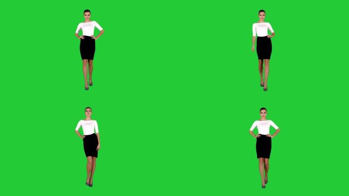 魅力时尚女性布鲁内特自信地走在绿色屏幕上，色键