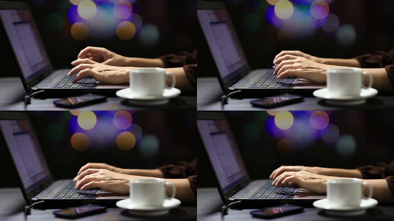 在咖啡馆里使用现代笔记本电脑的年轻女子