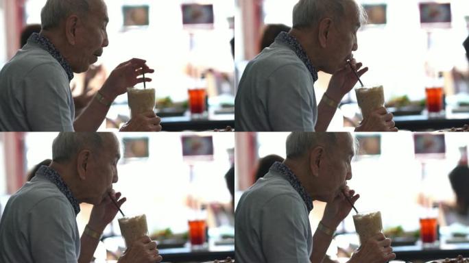 亚洲高级男子喝稻草冰沙，退休概念