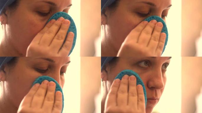 年轻女子用海绵擦脸