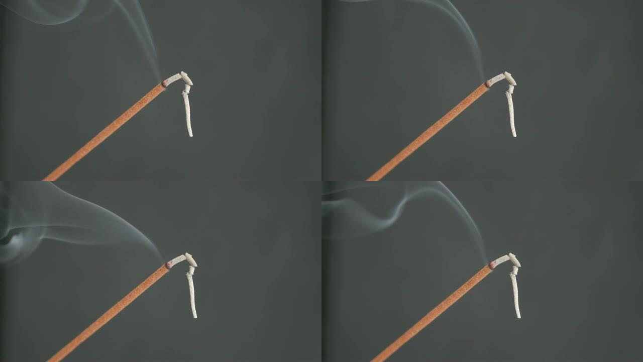 从燃烧的香棒传播的芳香烟雾特写4K 2160p 30fps超高清镜头-芳香生物材料燃烧用于冥想目的3
