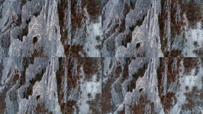 无人机: 鸟瞰非常高的锯齿状岩层，如针，攀登目的地，极限运动，高位置的洞穴，国家公园，特写，旅行目的