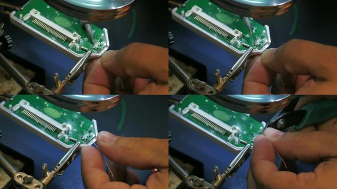 特写一个人在USB设备上焊接引脚的镜头