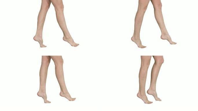 美丽的女性腿在白色背景的脚趾上优雅行走
