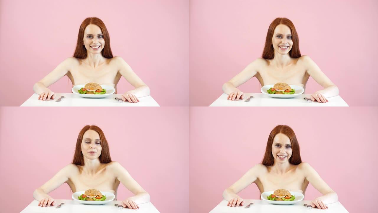 快乐的厌食症女孩挣扎着吃汉堡的诱惑。
