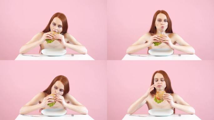 快乐厌食症女孩贪婪地吃汉堡。违反饮食。厌食症。