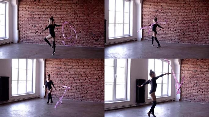 艺术体操: 在体操学校，黑色身体的女孩在带有窗户和砖墙背景的工作室里用粉红丝带进行体操练习。锻炼，慢