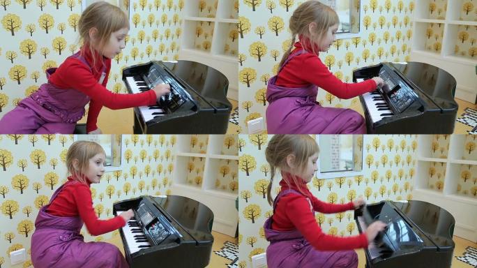 女孩在玩具钢琴上演奏