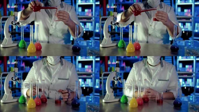 将溶液从烧瓶中倒入化学实验室的玻璃烧杯中。对液体进行科学体验。