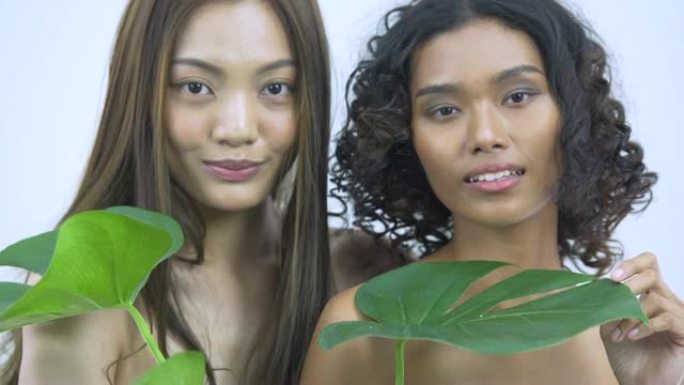 美丽的亚洲年轻模特女人的脸和皮肤与植物