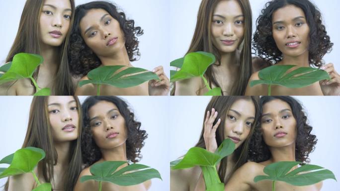美丽的亚洲年轻模特女人的脸和皮肤与植物