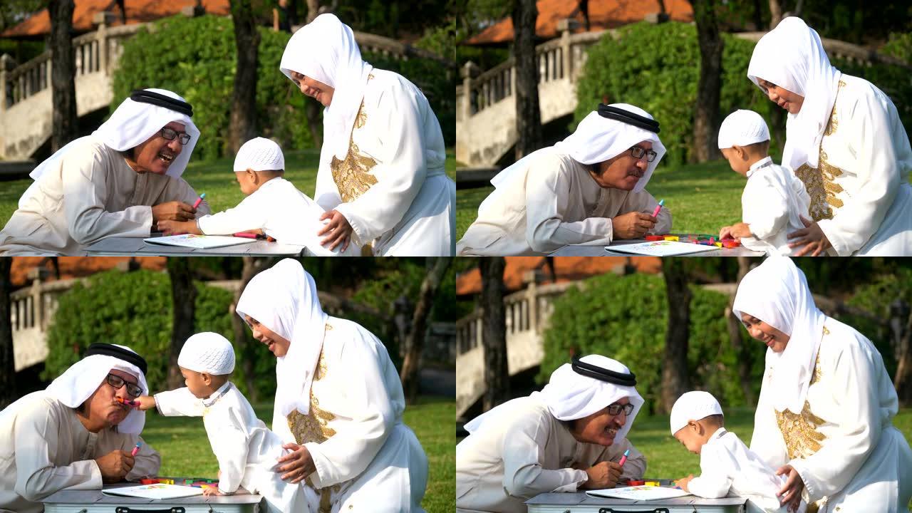 手持侧视图: 穆斯林祖父和母亲教儿子早上在阳光下在公园绘画
