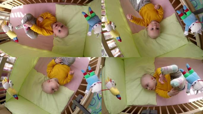 好奇的宝贝看旋转木马玩具在床上旋转。4K