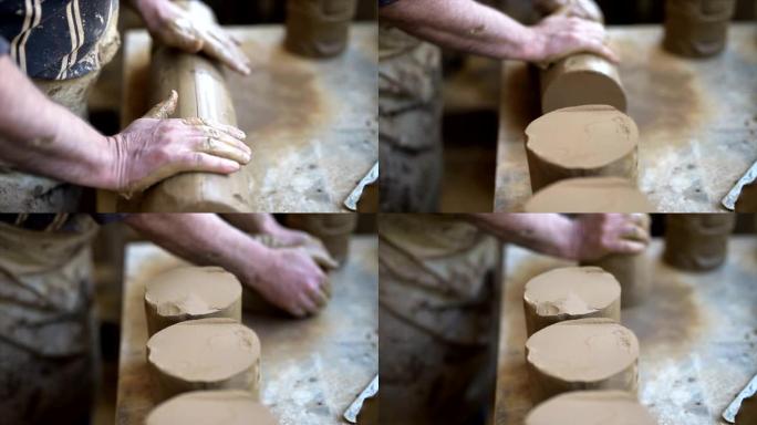 陶艺大师的男性手为陶轮准备粘土。