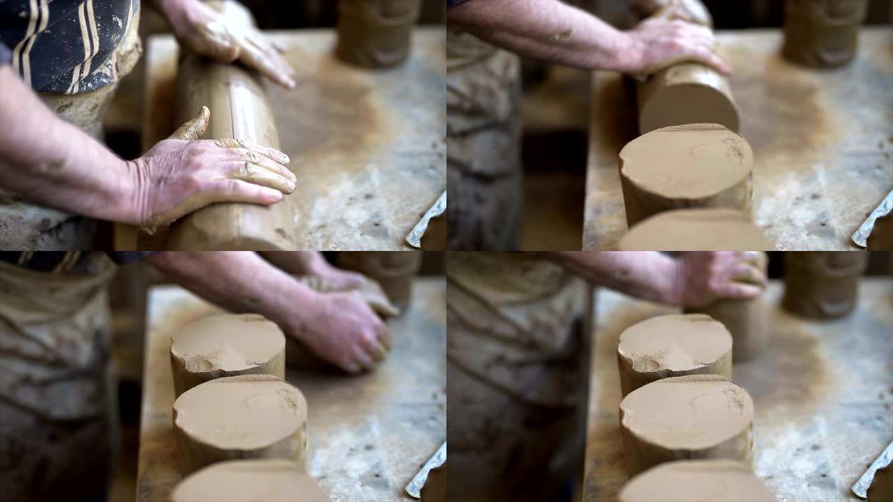 陶艺大师的男性手为陶轮准备粘土。