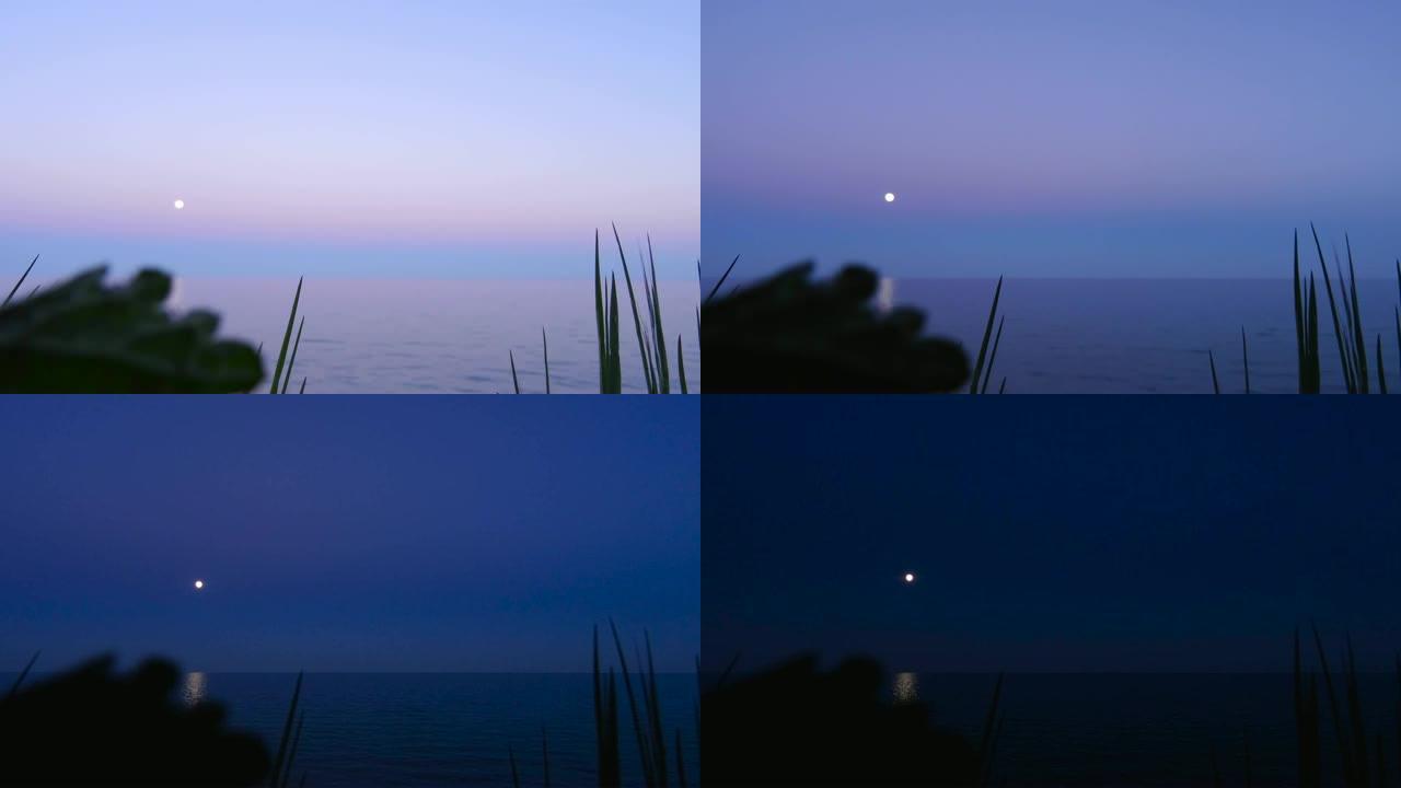 黄昏月亮出现在海上夜景当黑暗到来时