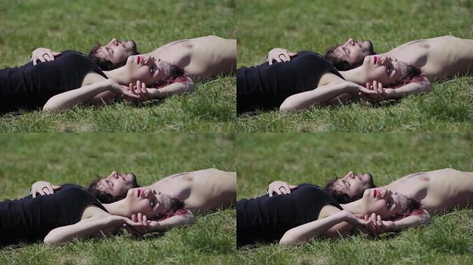 恋爱中的男人和女人躺在草地上牵着手，爱，情人，秋天
