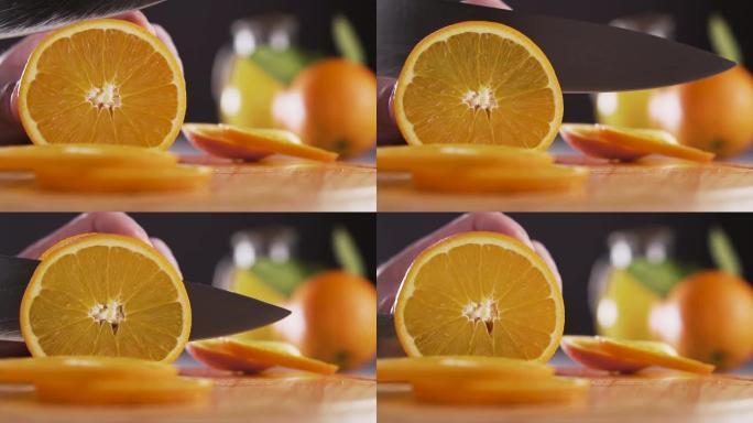 男士在砧板上手工切割新鲜橙色。健康饮食、烹饪和节食理念。慢动作。