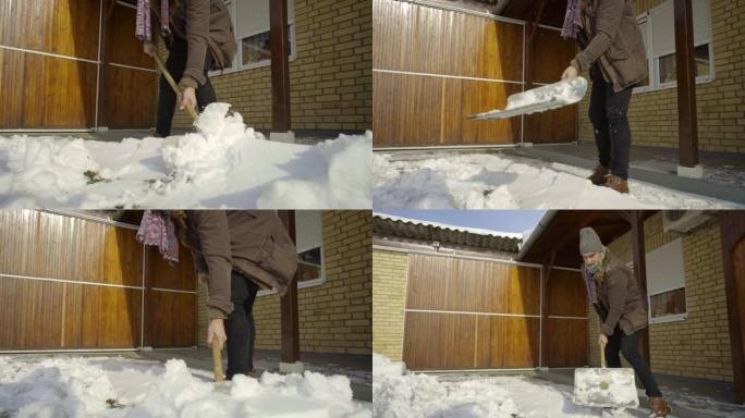男子在院子里铲新雪