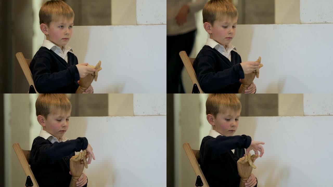 小男孩玩木制假人手
