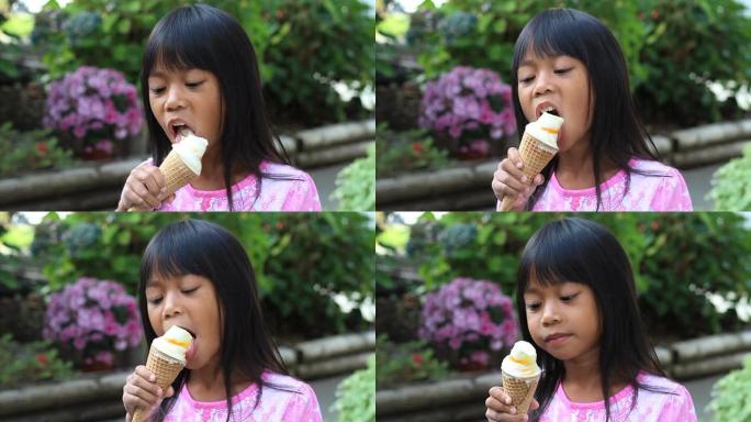 吃冰淇淋蛋卷的亚洲小女孩