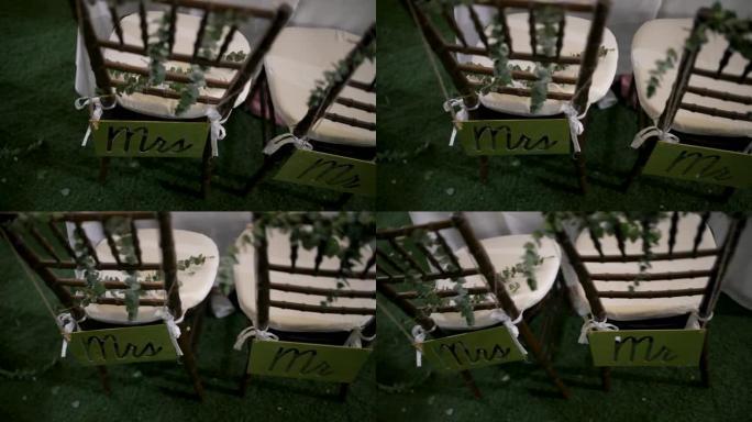 婚礼上的装饰，新娘和新郎的椅子上有标志