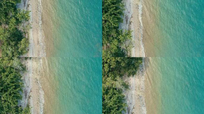 令人惊叹的空中无人机偏远热带海洋海岸的最小几何图像，有多石海滩郁郁葱葱的雨林丛林和从上往下看的水晶般