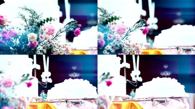 CU Dolly right: 在模糊的婚礼蛋糕背景下为婚礼装饰的一束鲜花。