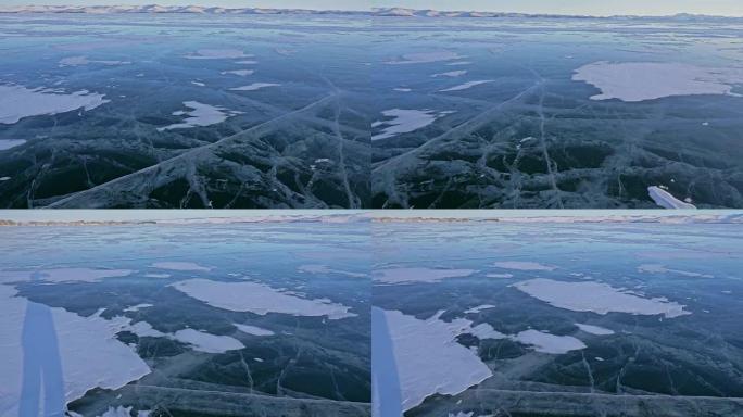 女人在贝加尔湖冰上的旅行。视点视图。去冬日岛旅行。女孩正走在冰石脚下。旅行者看着美丽的冰窟。背包客在