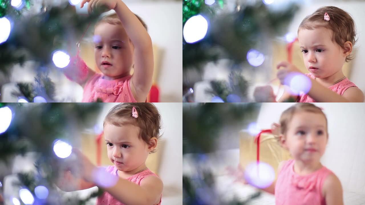 可爱的小女孩装饰圣诞树。