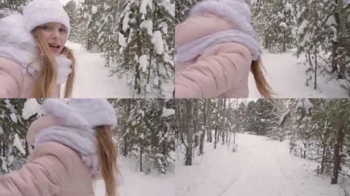 女孩的手穿过白雪皑皑的树林。