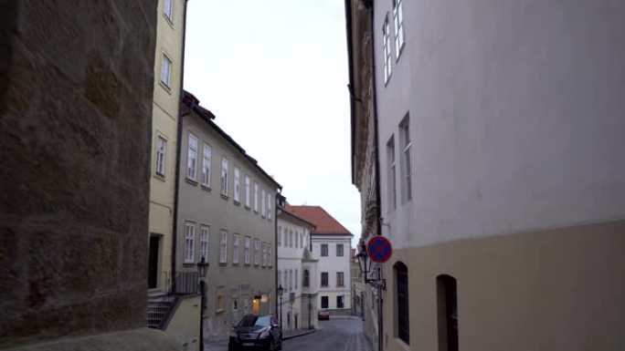 手持视图: 从布拉格当地街道高楼之间的小门走出