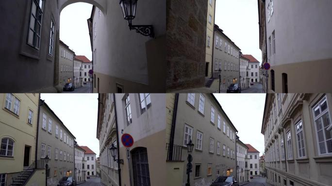 手持视图: 从布拉格当地街道高楼之间的小门走出