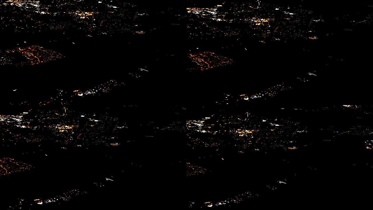 4k镜头arial视图飞行的airlpane穿过夜光城市场景伦敦