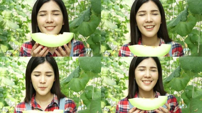 年轻美丽的亚洲女性水果蔬菜乡村农民吃了一片甜瓜，在西瓜农场里闻到了味道