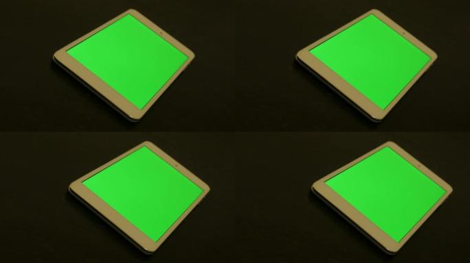 木桌上的平板电脑显示绿屏显示4K 3840x2160 UHD素材-个人平板电脑上的绿屏显示4K 21