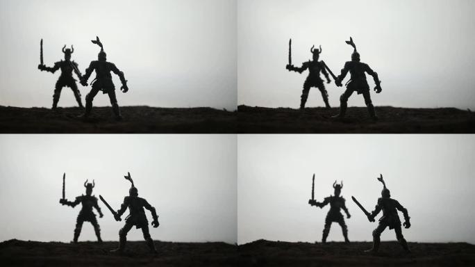 中世纪有骑兵和步兵的战斗场景。人物的剪影作为单独的物体，在日落有雾的背景下战士之间的战斗。选择性聚焦