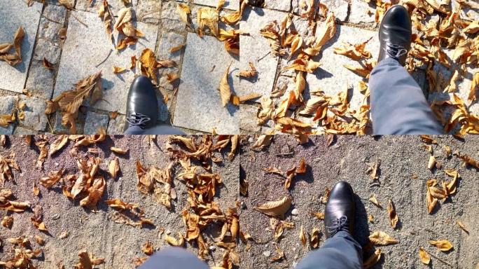 男子在秋天用4k慢动作60fps行走在满是树叶的地面上