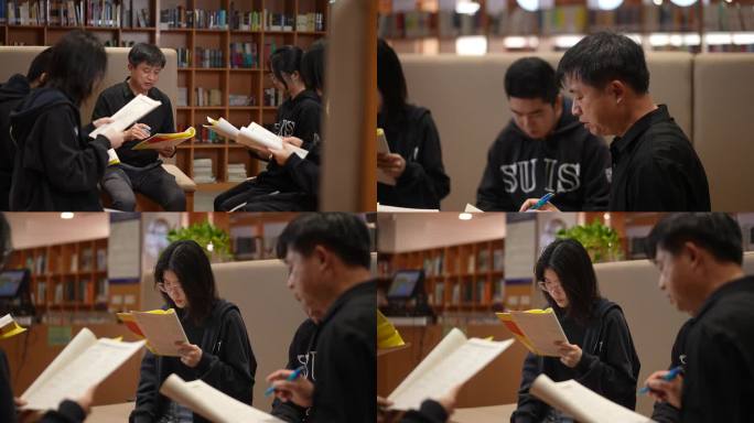 老师带同学在图书馆学习