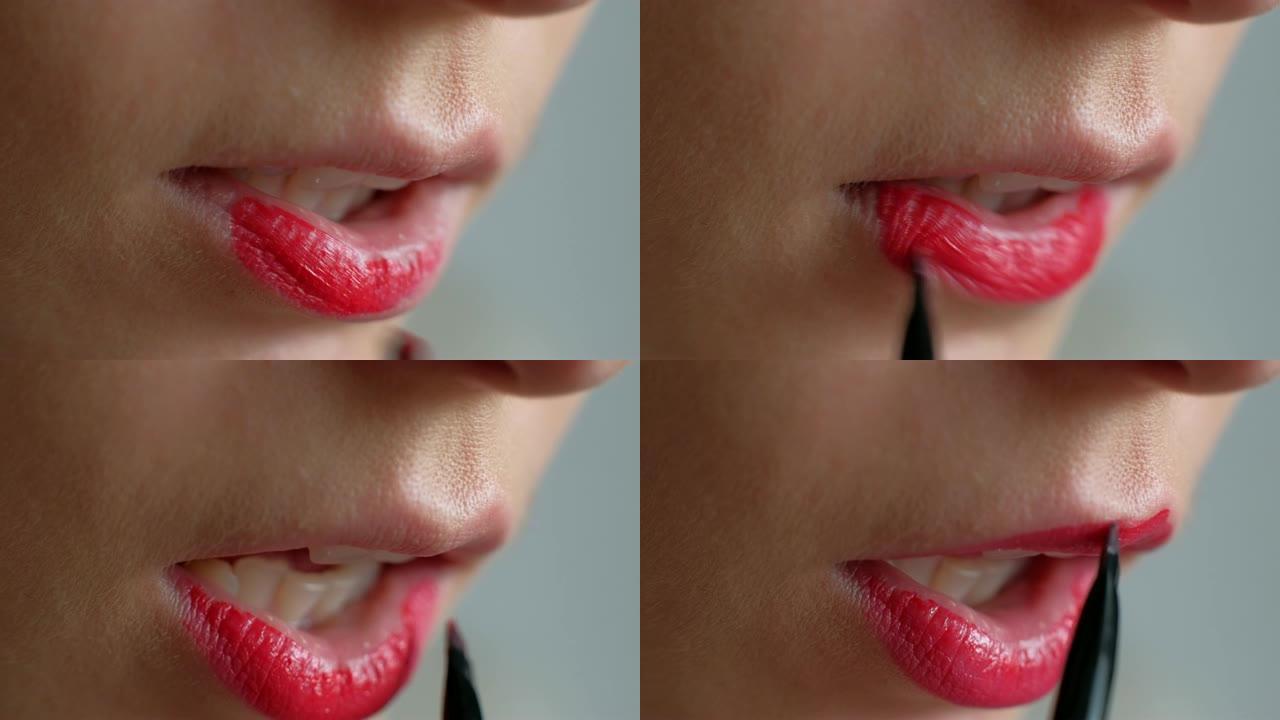 这个女孩在嘴唇上化妆。在嘴唇上涂红色唇膏。特写