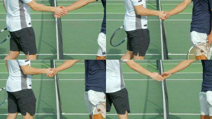 两名网球运动员在网上握手。