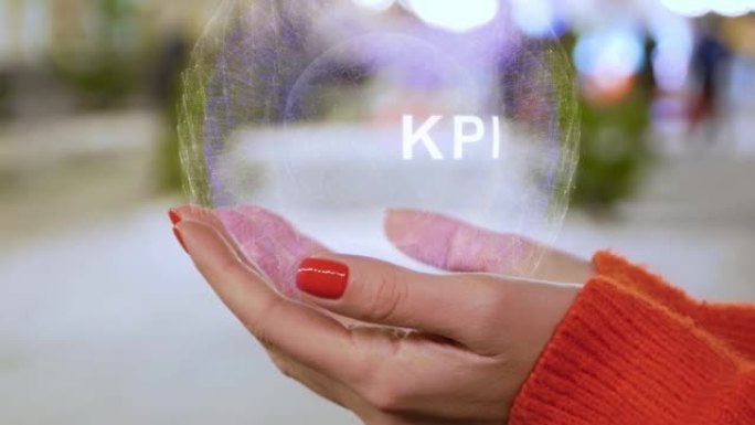 女性双手拿着带有文本KPI的概念全息图