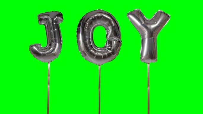 漂浮在绿色屏幕上的氦气银气球字母带来的欢乐单词