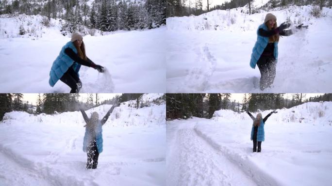 年轻漂亮的女孩走在白雪皑皑的冬季森林里。她既快乐又开朗。女孩扔雪。慢动作。
