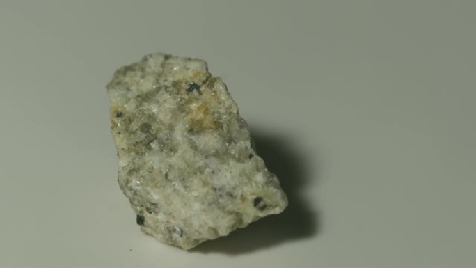 白色背景旋转的单氮花岗岩矿物样品